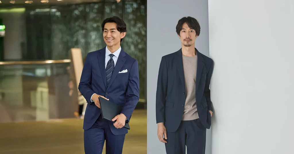 亞洲男士穿深藍成套西裝和領帶,旁邊男士穿深藍西裝外套配灰色針織上衣