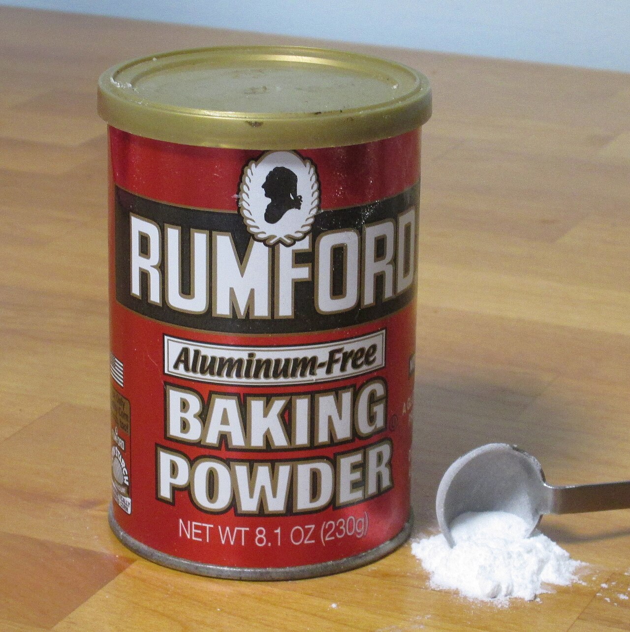 Rumford 泡打粉罐與量匙中的粉末，示範包裝上 baking powder 的商品名稱